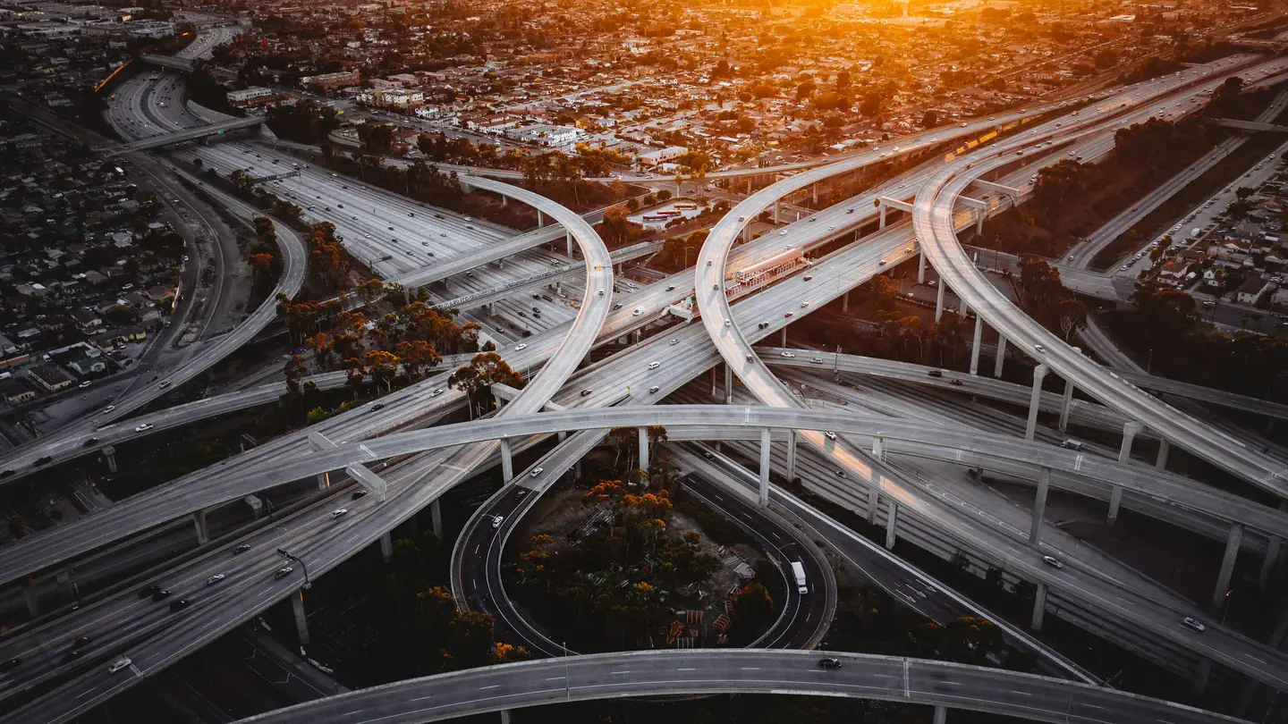 Aerial view of a multi-level highway interchange at sunset