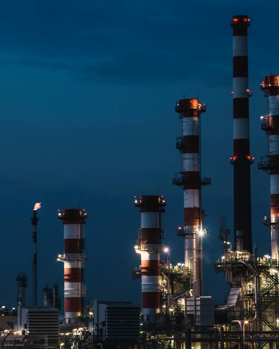 Refinery stacks and process units illuminated at dusk